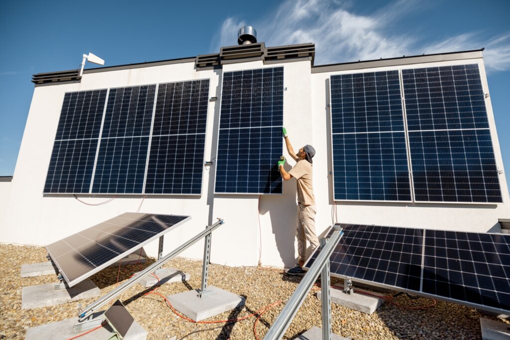 Man installing solar panels on a rooftop